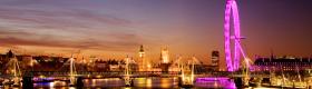 View along the Thames: Big Ben, Westminster, the London Eye, South Bank and the Hungerford Bridge lit up at dusk. 